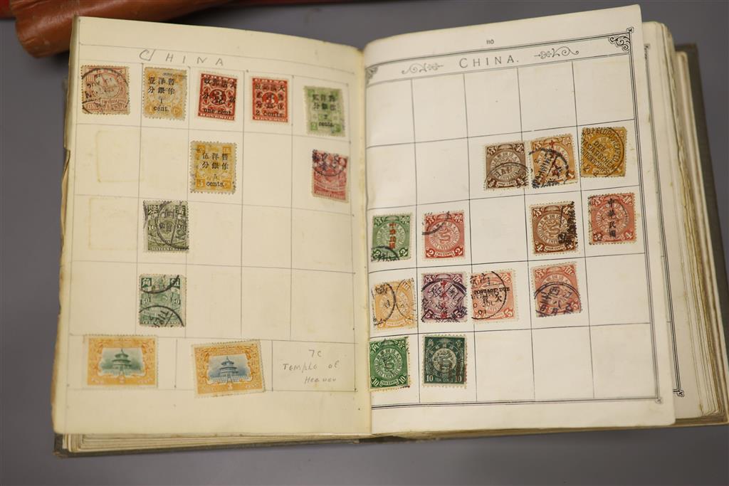 A Stanley Gibbons red stamp album and two others, each mounted with an accumulation of all world postage stamps